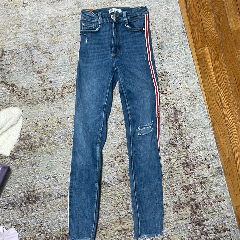 Zara skinny jeans with trendy red stripe down both sides.